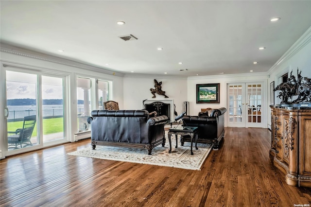 living room featuring french doors, dark hardwood / wood-style flooring, a water view, and ornamental molding