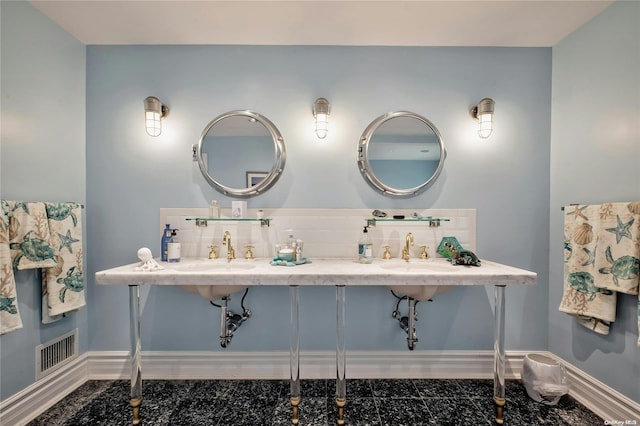 bathroom featuring dual sinks