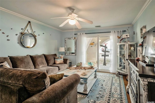 living room featuring hardwood / wood-style flooring, ceiling fan, and crown molding