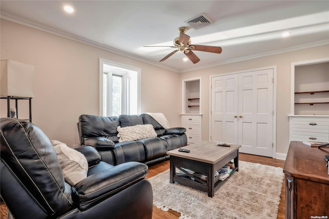 living room featuring light wood-type flooring and ornamental molding