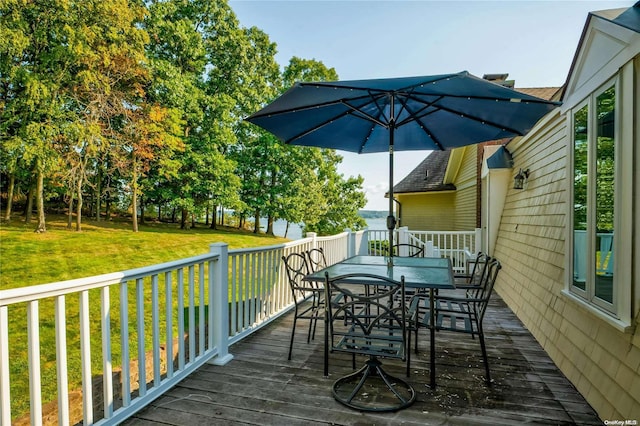 wooden terrace with a lawn