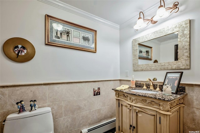 bathroom featuring vanity, a baseboard heating unit, toilet, ornamental molding, and tile walls