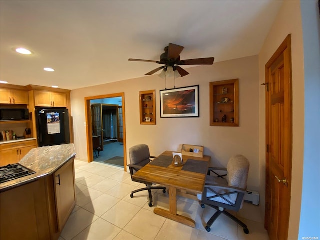 tiled home office featuring ceiling fan