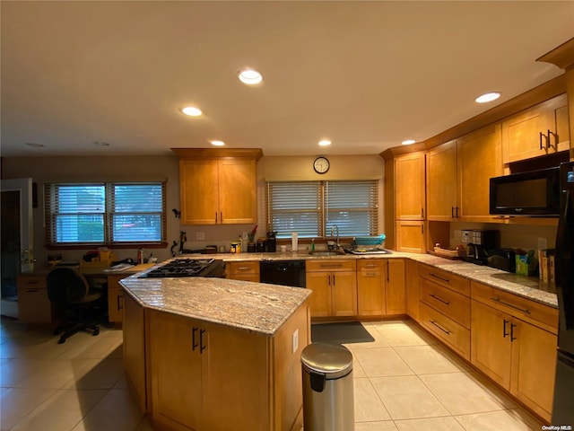 kitchen featuring black appliances, light tile patterned flooring, light stone countertops, and sink