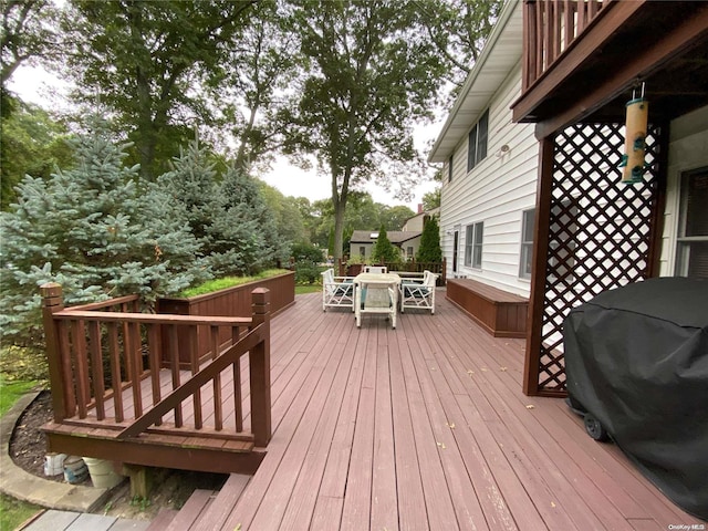 wooden terrace with a grill