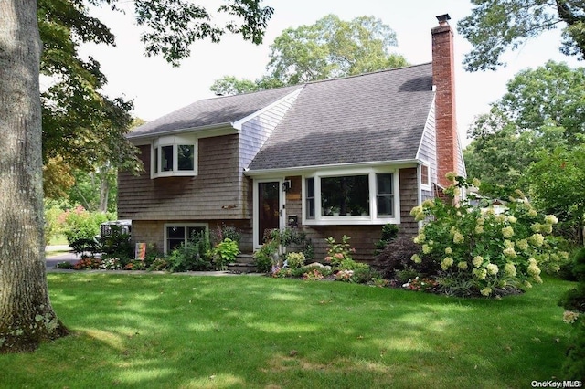 tri-level home with a front yard