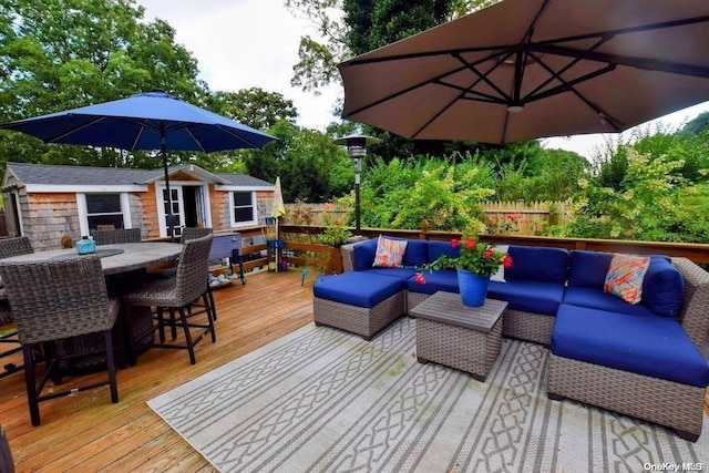 deck with an outdoor structure and an outdoor hangout area