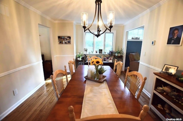 dining room featuring crown molding, dark wood-type flooring, and a notable chandelier