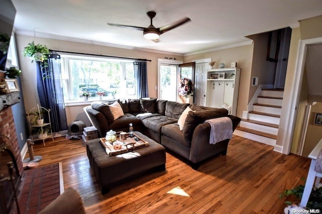 living room featuring wood-type flooring, ceiling fan, and crown molding