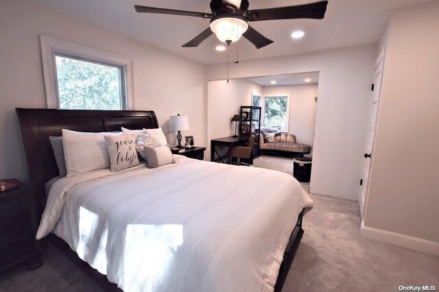 bedroom with carpet, ceiling fan, and multiple windows