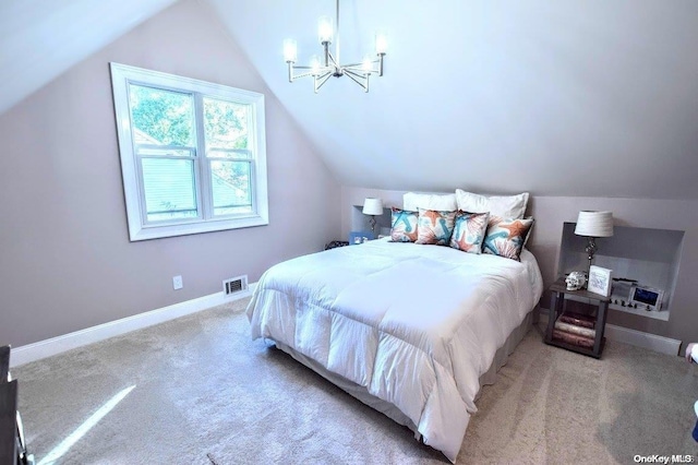 carpeted bedroom with lofted ceiling and an inviting chandelier