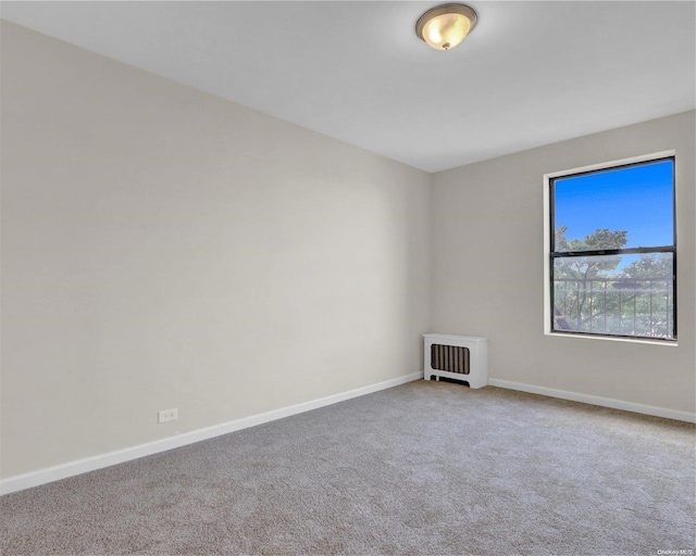 carpeted spare room featuring heating unit