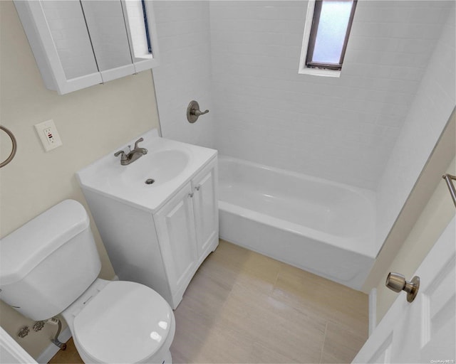 full bathroom with vanity, toilet, and tiled shower / bath combo