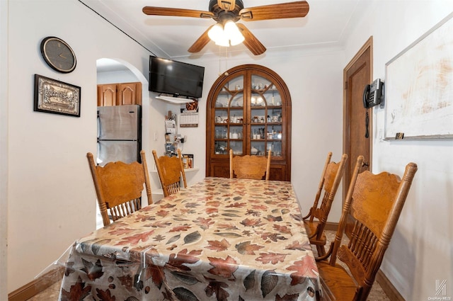 dining area featuring ceiling fan and crown molding