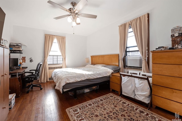 bedroom with multiple windows, ceiling fan, and dark hardwood / wood-style flooring