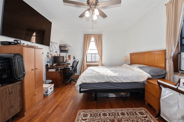 bedroom featuring hardwood / wood-style flooring, ceiling fan, and vaulted ceiling