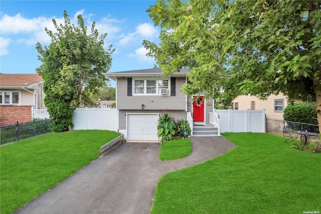 split foyer home with a garage and a front lawn