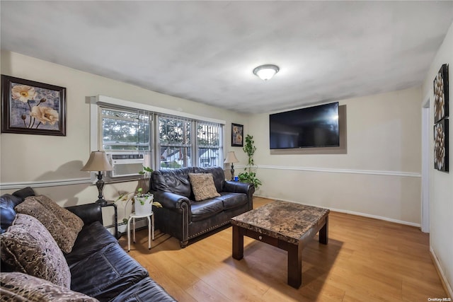 living room with light hardwood / wood-style floors, cooling unit, and a baseboard heating unit