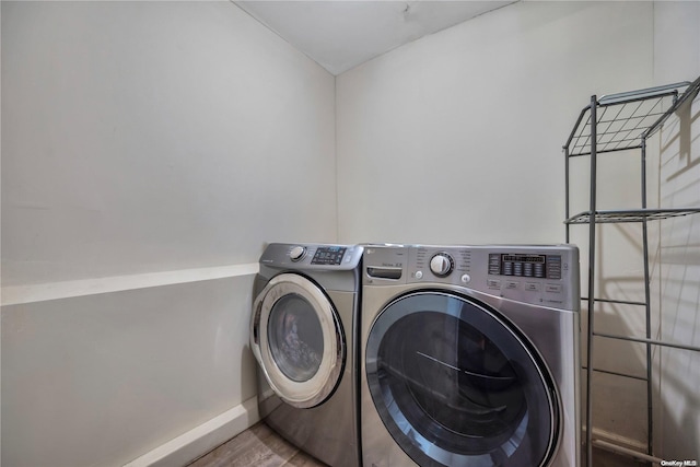 washroom featuring hardwood / wood-style floors and washer and dryer