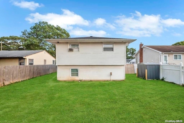 back of house with a lawn