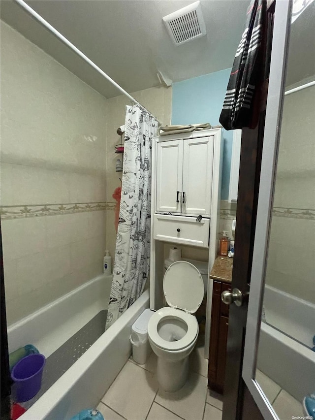 bathroom with tile patterned flooring, shower / bath combination with curtain, and toilet