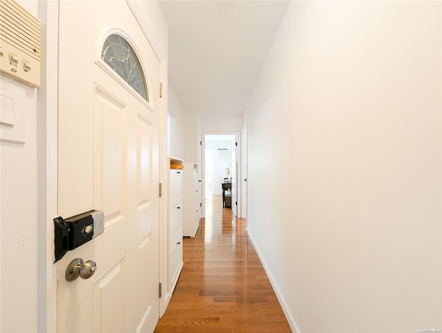 hallway with hardwood / wood-style flooring