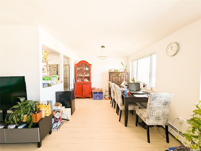 dining room featuring light hardwood / wood-style flooring and a baseboard heating unit