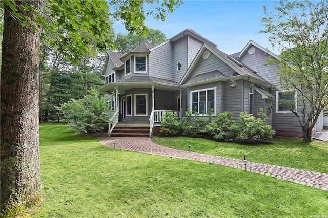 view of front of home featuring covered porch and a front yard