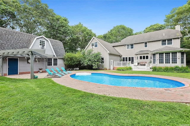 view of swimming pool with a patio area, a pergola, a yard, and a wooden deck