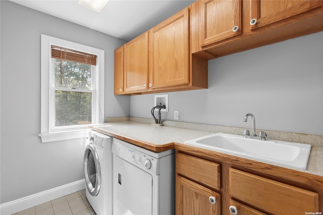 washroom with cabinets, light tile patterned flooring, washer / dryer, and sink