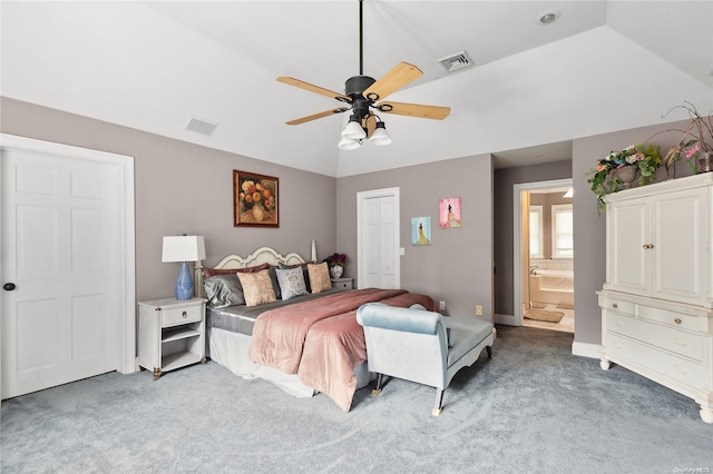 carpeted bedroom featuring ceiling fan, ensuite bath, and vaulted ceiling