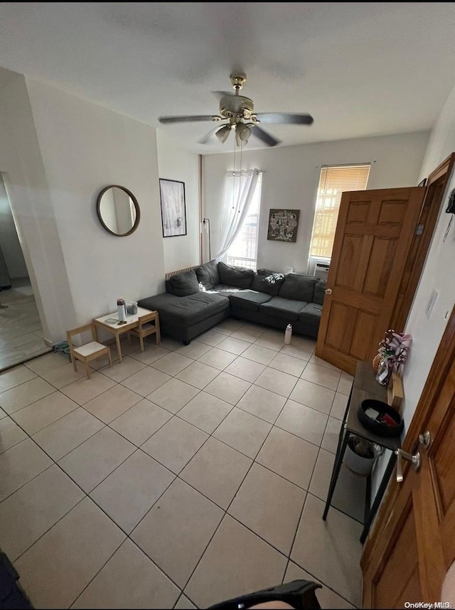 unfurnished living room with ceiling fan and light tile patterned floors