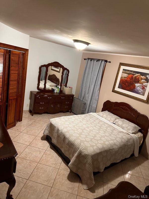 303 Milford St, Brooklyn, NY 11208 - bedroom with light tile patterned floors and a closet