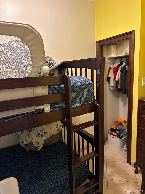303 Milford St, Brooklyn, NY 11208 - bedroom with a closet and light tile patterned flooring