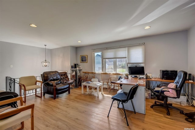 office with light hardwood / wood-style floors and a baseboard radiator