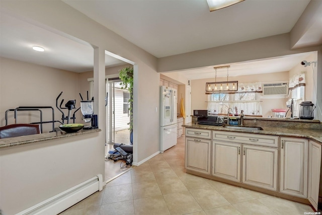 kitchen featuring pendant lighting, sink, white fridge with ice dispenser, a wall mounted AC, and a baseboard radiator