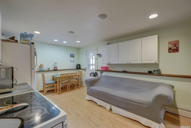 interior space with light hardwood / wood-style floors and a baseboard heating unit