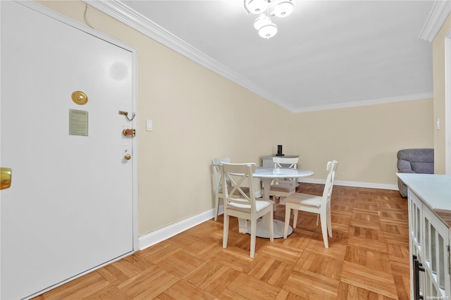 dining space with crown molding and light parquet floors