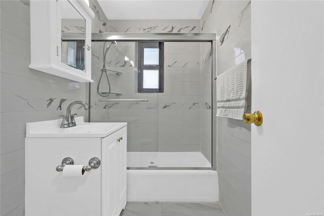 bathroom featuring vanity and tile walls