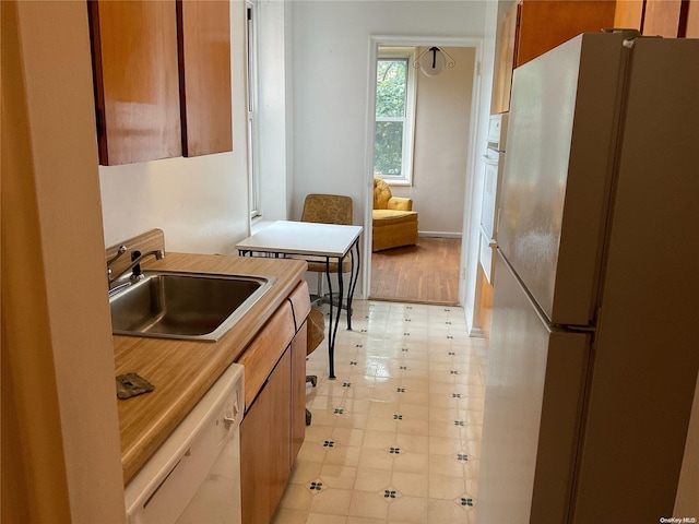 kitchen with white appliances and sink