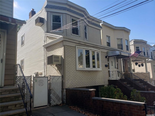 view of front of house with a wall mounted air conditioner