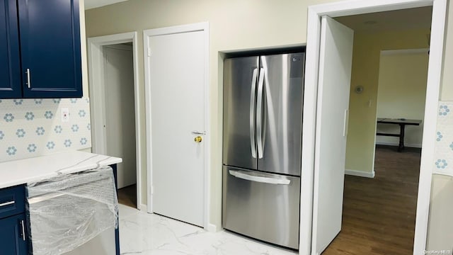 2041 New Hyde Park Rd, New Hyde Park, NY 11040 - kitchen featuring blue cabinets, freestanding refrigerator, light countertops, and baseboards