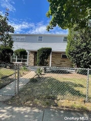 2041 New Hyde Park Rd, New Hyde Park, NY 11040 - view of front facade featuring a fenced front yard