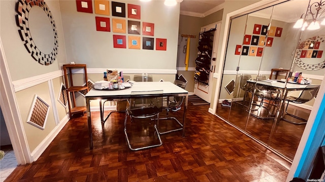 dining room with dark parquet flooring and ornamental molding