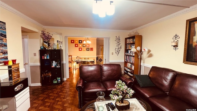 living room featuring a chandelier, dark parquet floors, and crown molding