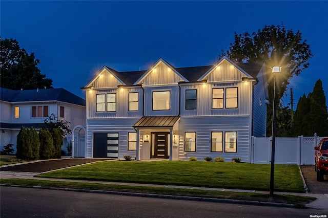 view of front facade featuring a garage and a yard