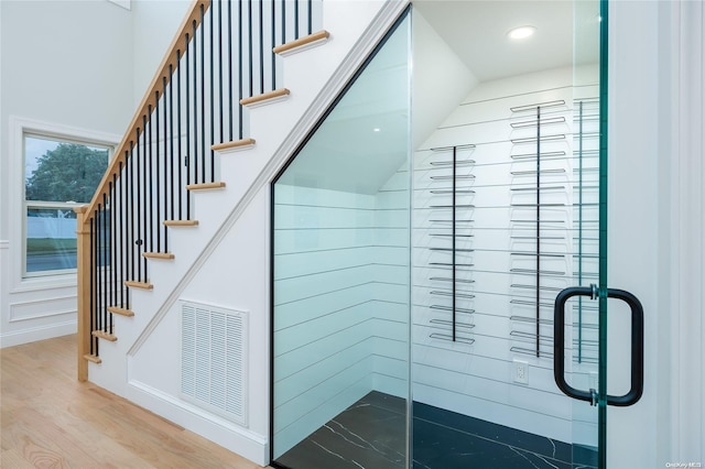 stairs featuring hardwood / wood-style floors