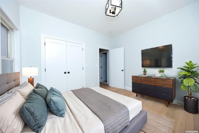 bedroom with a closet and light hardwood / wood-style floors