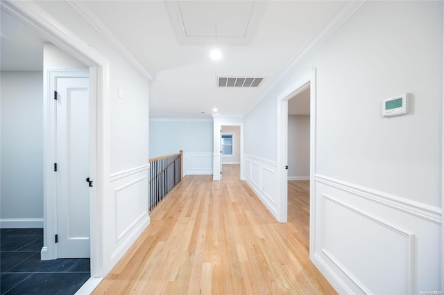 corridor featuring light hardwood / wood-style flooring and ornamental molding