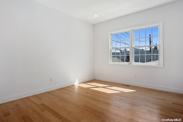 spare room featuring light wood-type flooring